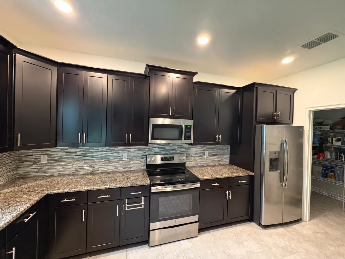 Kitchen before refinishing, with dark wood cabinets