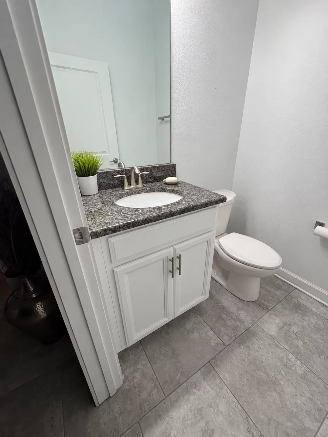 Bathroom vanity with refinished white doors and silver handles