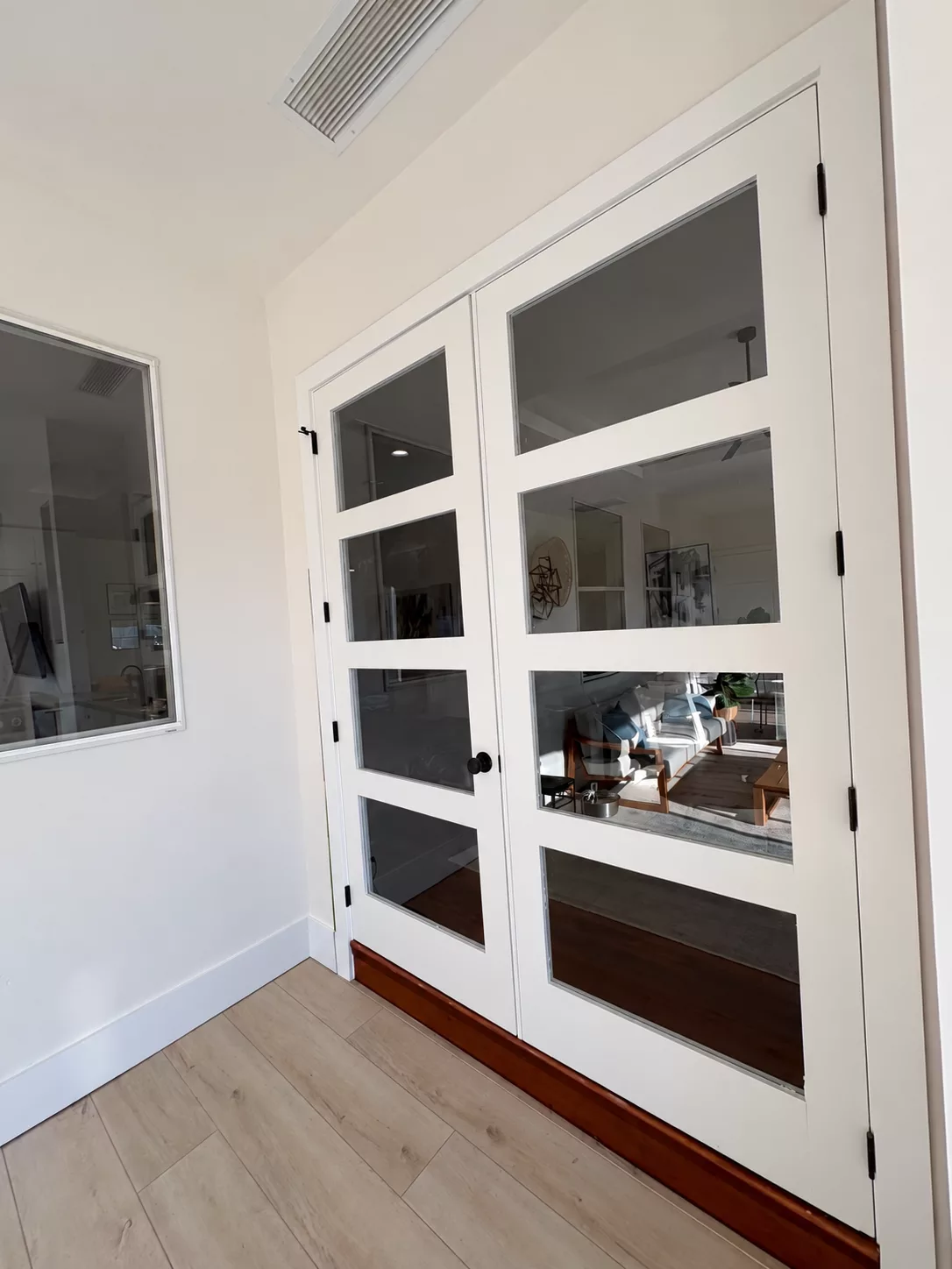 French doors painted white in a bright living room