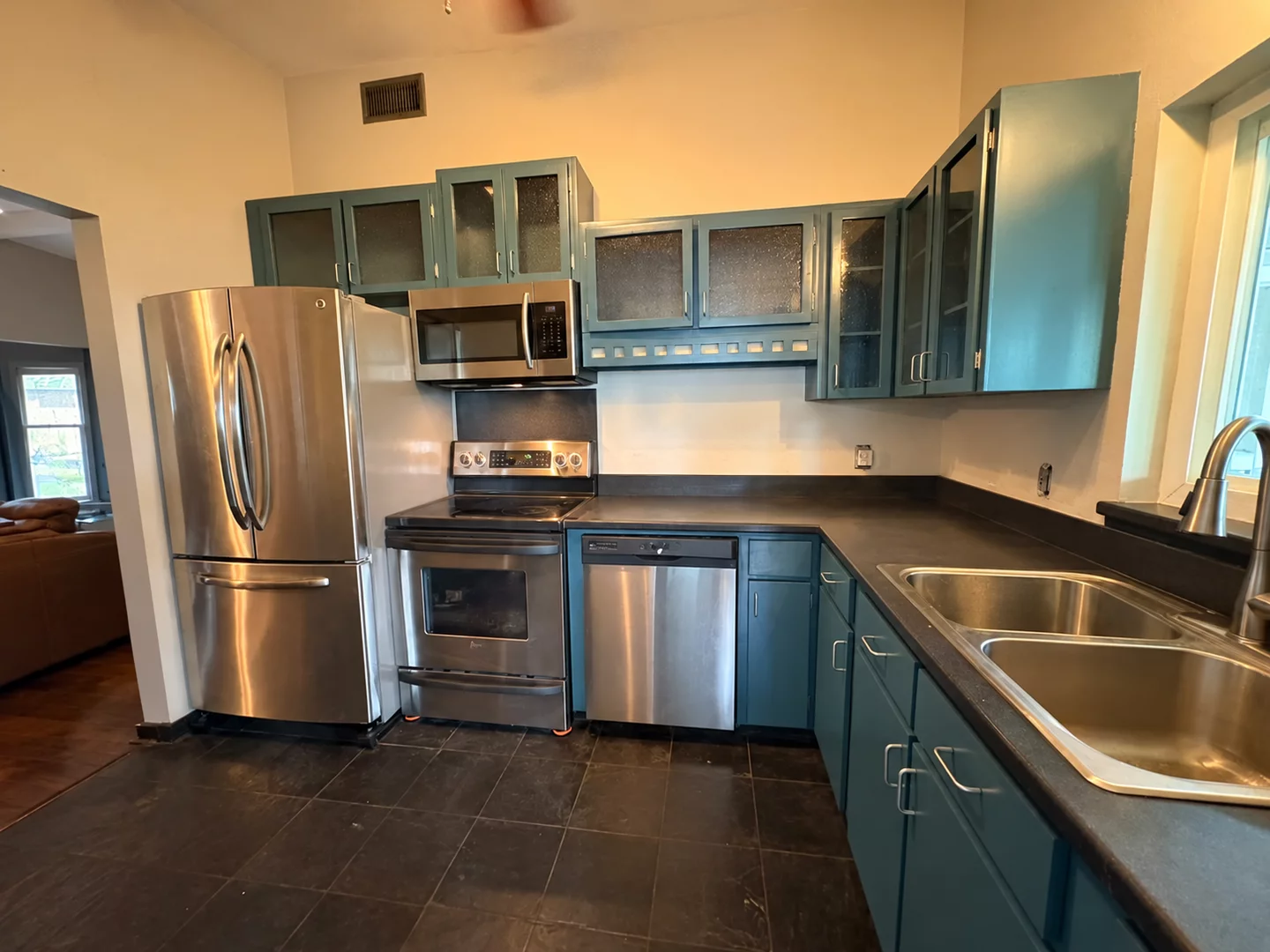 Kitchen with blue-green refinished cabinets