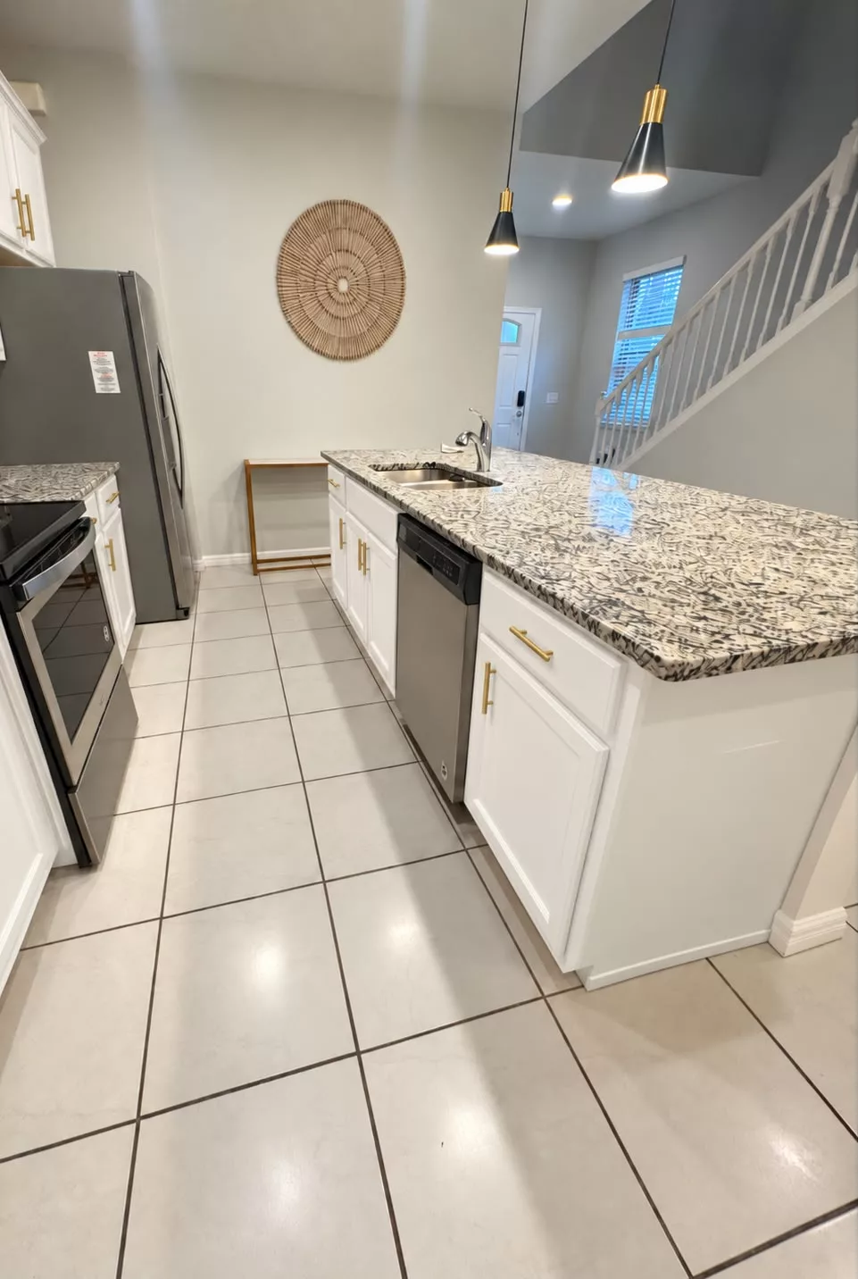 Kitchen island cabinets refinished in white beneath a granite countertop