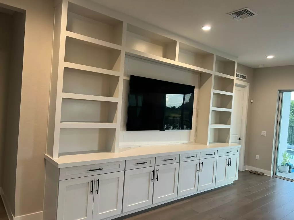 White built-in entertainment center with detailed cabinetry
