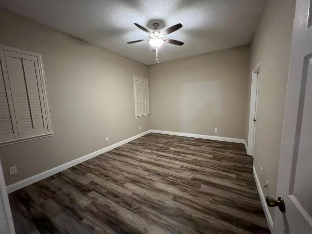 Room painted in a warm neutral shade with white trim